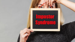 Girl holding up a sign showing leaders and professionals with impostor syndrome