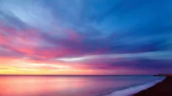 A sunset and beach is helpful in learning to use profound acceptance